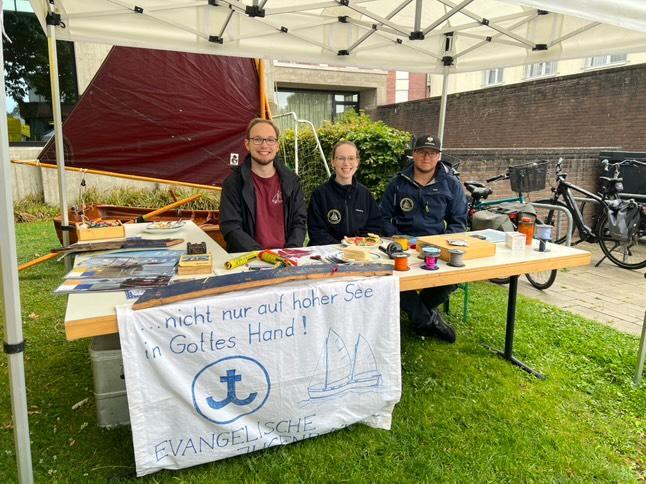 Bild vom Stand der SeglerInnen beim Gemeindefest mit Segelboot im Hintergrund.